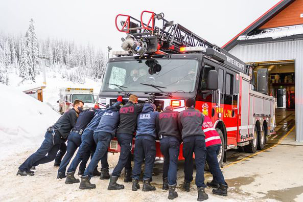 New Big White Fire Department ladder truck pushed into fire station