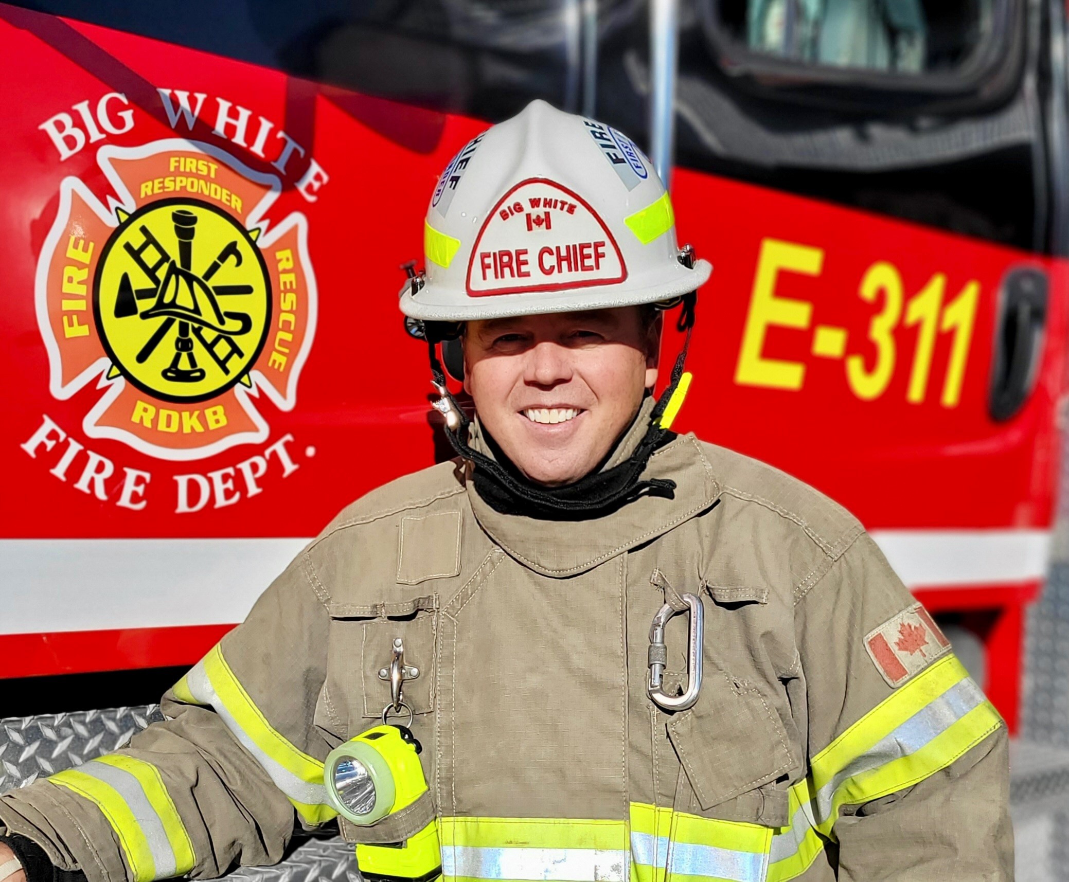 Fire Chief Josh Foster posing next to fire truck